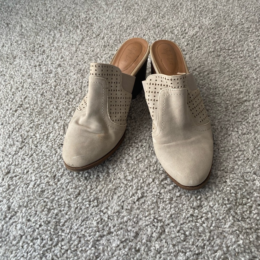 Heeled tan clogs.